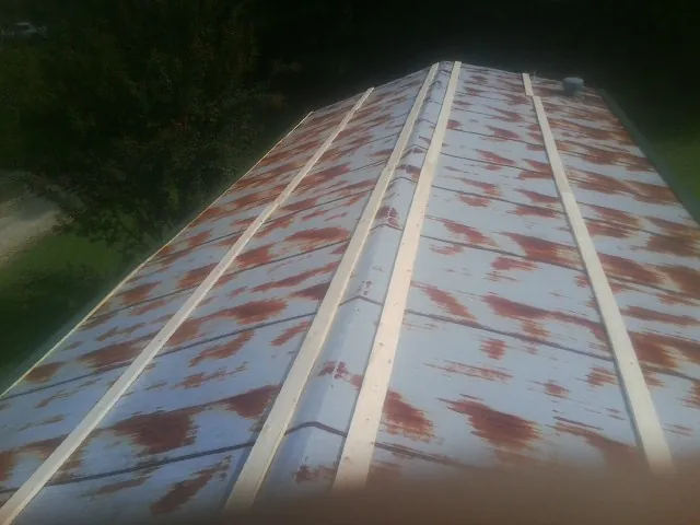 Rusted metal roof panels with new wood purlins before replacement — Storm Damage Roof Repair in Vicksburg by Roofing Brothers