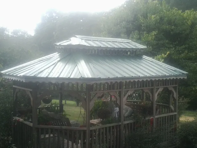 Two tier green metal roof on a garden gazebo in Vicksburg